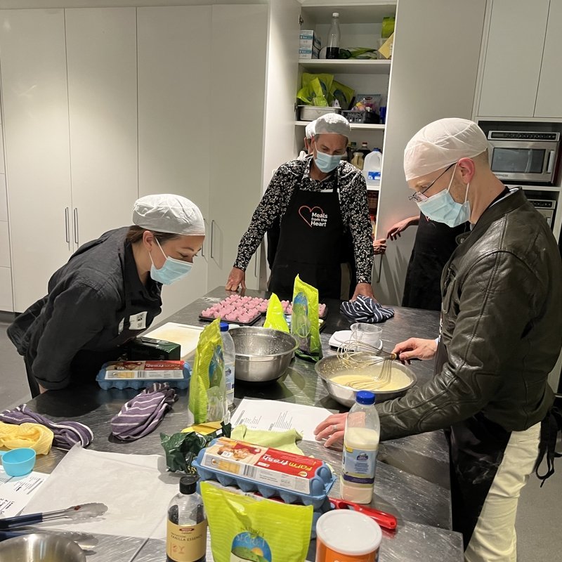 Three people cooking together